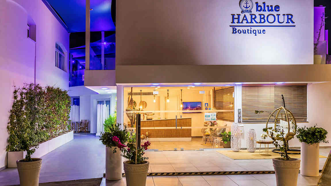 Hotellentré vid natt med fönster och inredning synligt. (AI-genererad text)