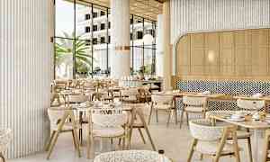 Restaurangmiljö med moderna bord och stolar, stora fönster som släpper in naturligt ljus och palmer utanför. (AI-genererad text)