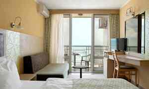 Ett hotellrum med havsutsikt och balkong. (AI-genererad text)