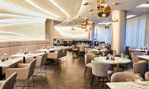 En elegant restaurang med modern inredning och bord dukade för gäster. (AI-genererad text)