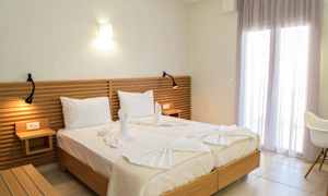 Två sängar med vit sängklädsel, ett trähuvudgavel och dekorativa handdukar formade som svanar. (AI-genererad text)