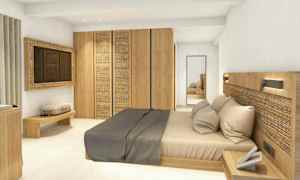 En hotelldesign med en modern säng, trädetaljer och minimalistiska möbler. (AI-genererad text)