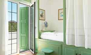 Ett rum med gröna möbler och en dörr som leder till en balkong. (AI-genererad text)