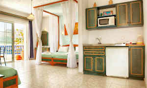 Ett ljust hotellrum med kokvrå och sängar inredda med grönt sänglinne. (AI-genererad text)