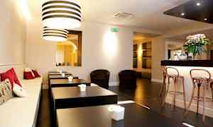 Ett modernt café med sittplatser och dekorativa lampor. (AI-genererad text)