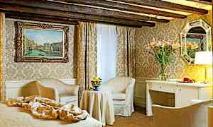 Ett elegant hotellrum med klassisk inredning inklusive två fåtöljer, bord, skrivbord och väggdekorationer. (AI-genererad text)