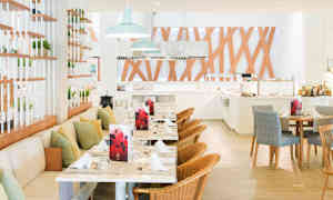 Öppen restauranglokal med bord, stolar och dekorativa träpaneler. (AI-genererad text)