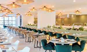 Restaurang med sittplatser, bord och belysning. (AI-genererad text)