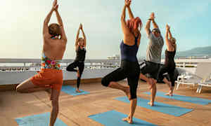 En grupp människor gör yogaövningar på en terrass. (AI-genererad text)