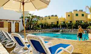 Bild med en utomhuspool omgiven av solstolar och grönska. (AI-genererad text)