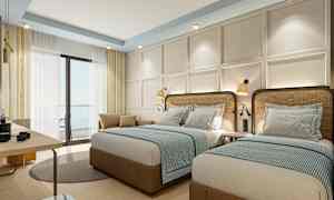 Hotellrum med två enkelsängar, ljus inredning och fönster med gardiner. (AI-genererad text)