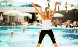 Person står framför en pool och håller upp händerna. (AI-genererad text)