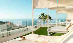 Solstolar på en terrass med utsikt över havet och staden. (AI-genererad text)