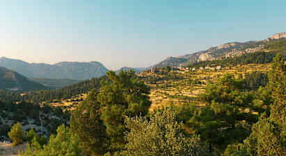 En landskapsvy med berg och träd i förgrunden. (AI-genererad text)