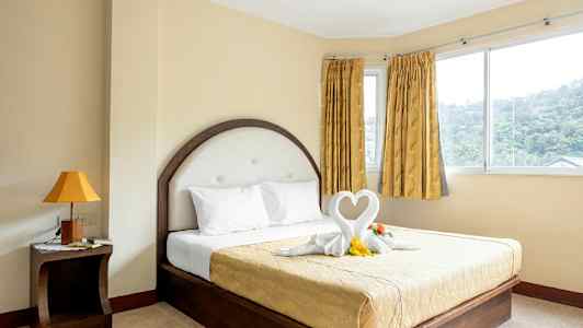 Rum med en säng och dekorationer formade som hjärtan. (AI-genererad text)