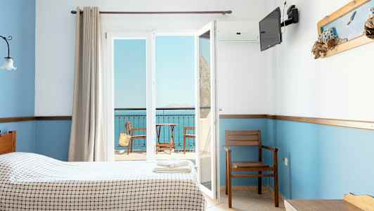 Hotellrum med två sängar, utsikt mot en balkong och havet. (AI-genererad text)