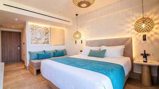 Hotellrum med dubbelsäng och sittmöbler. (AI-genererad text)