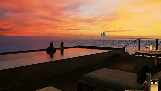 Två personer sitter i en infinitypool vid solnedgången med en segelbåt på havet i bakgrunden. (AI-genererad text)