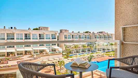 Hotell med poolområde sett från en balkong. (AI-genererad text)