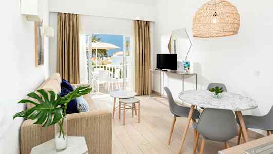 Ljust inredd lägenhet med öppen planlösning och balkong med utsikt. (AI-genererad text)