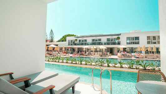 Privat poolområde med utsikt över ett modernt hotellkomplex. (AI-genererad text)