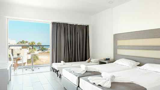 Ett hotellrum med två uppsatta sängar och en balkong med utsikt. (AI-genererad text)