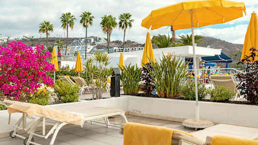 Solstolar och parasoller vid en terrass med utsikt. (AI-genererad text)