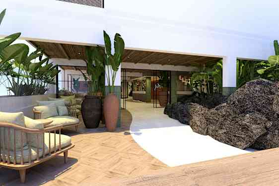 Ett hotellområde med sittplatser, växter och stenarna. (AI-genererad text)