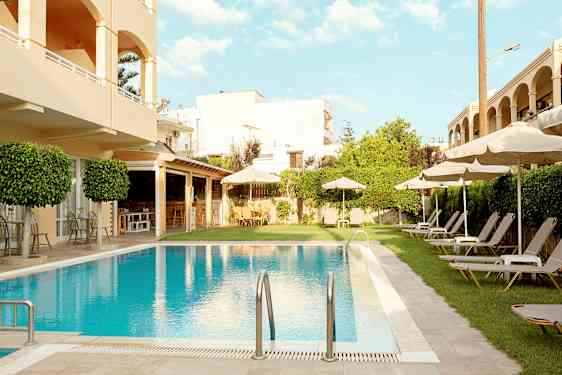 Hotellområde med pool, solstolar och parasoll. (AI-genererad text)