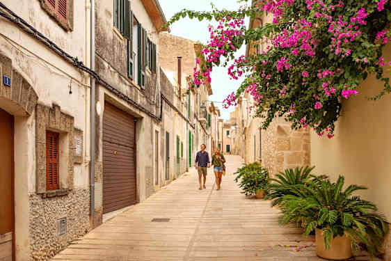 En man och en kvinna håller handen i en gränd.