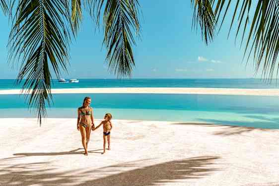 Mom and son on beach on Maldives