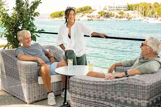 Stor grupp spelar fotboll på stranden