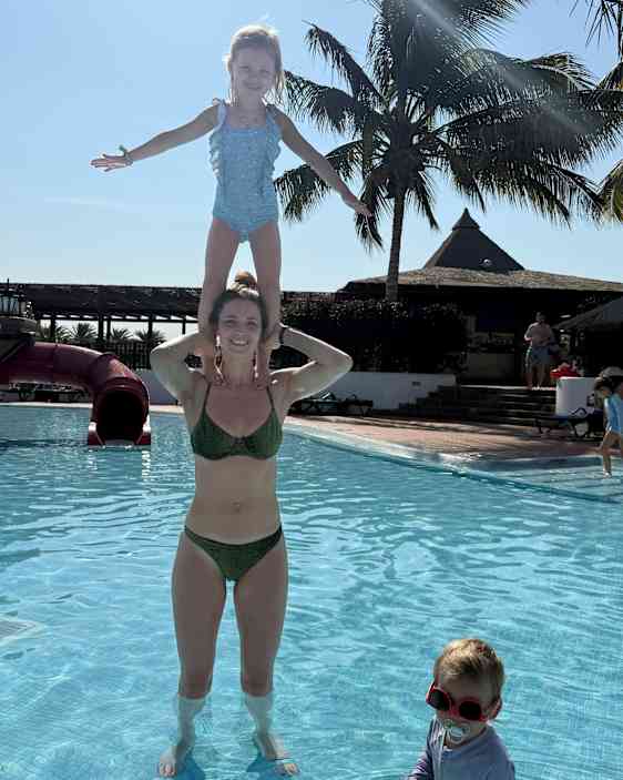 Mor och dotter leker i bassängen