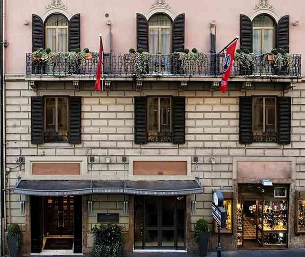 Byggnaden har en klassisk fasad med balkonger och blomplanteringar. (AI-genererad text)