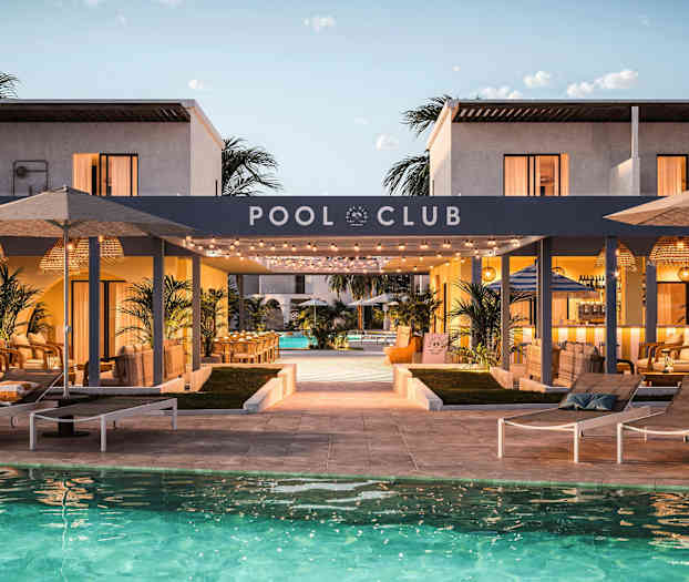 Bild av en poolklubb med solstolar vid en swimmingpool, omgiven av modern arkitektur och utomhusmöbler i en lounge-atmosfär. (AI-genererad text)