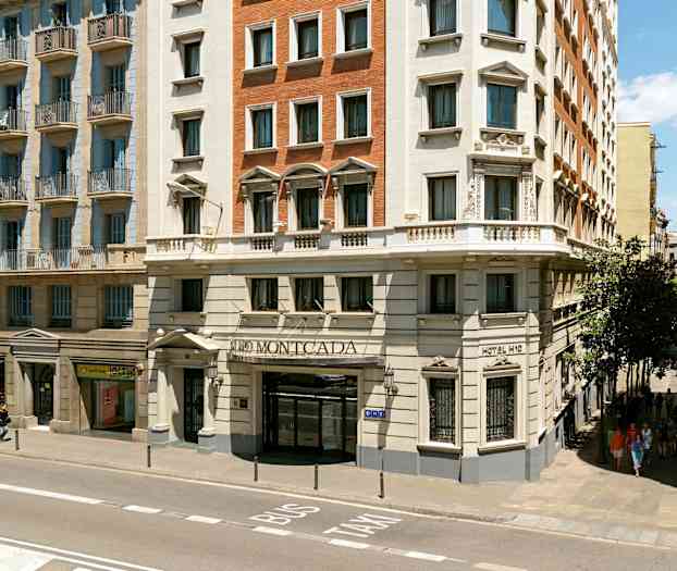 Byggnad med hotellfasad vid en gata i stadsmiljö. (AI-genererad text)