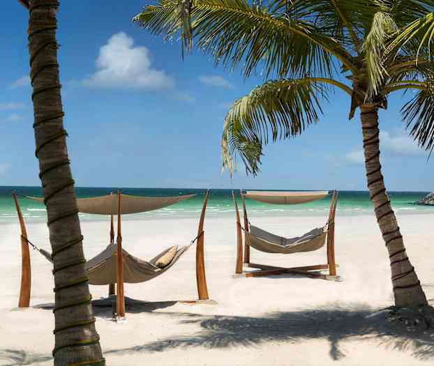 Soliga stränder med hängmattor och palmer vid havet. (AI-genererad text)