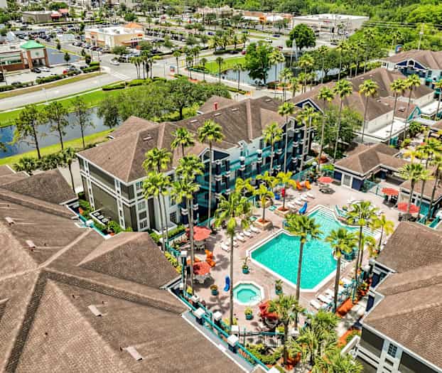 Bild av en semesteranläggning med swimmingpool och omgivande byggnader, sett från ovan. (AI-genererad text)