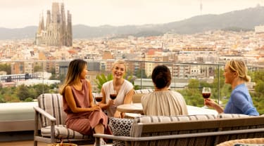 Fyra vänner på en takterrass i Barcelona