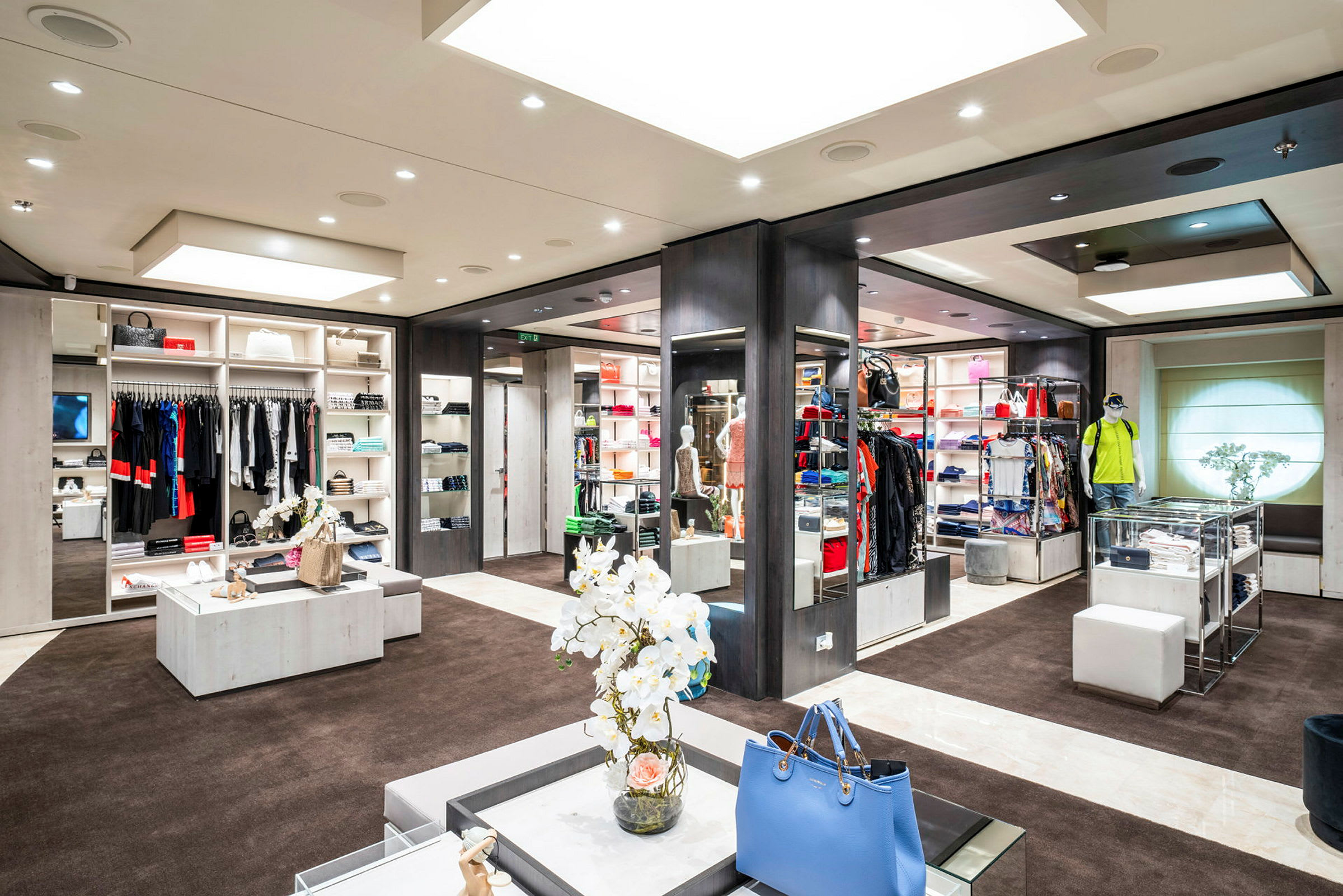 Bild på en butik med kläder och accessoarer på hyllor och ställ. (AI-genererad text)
