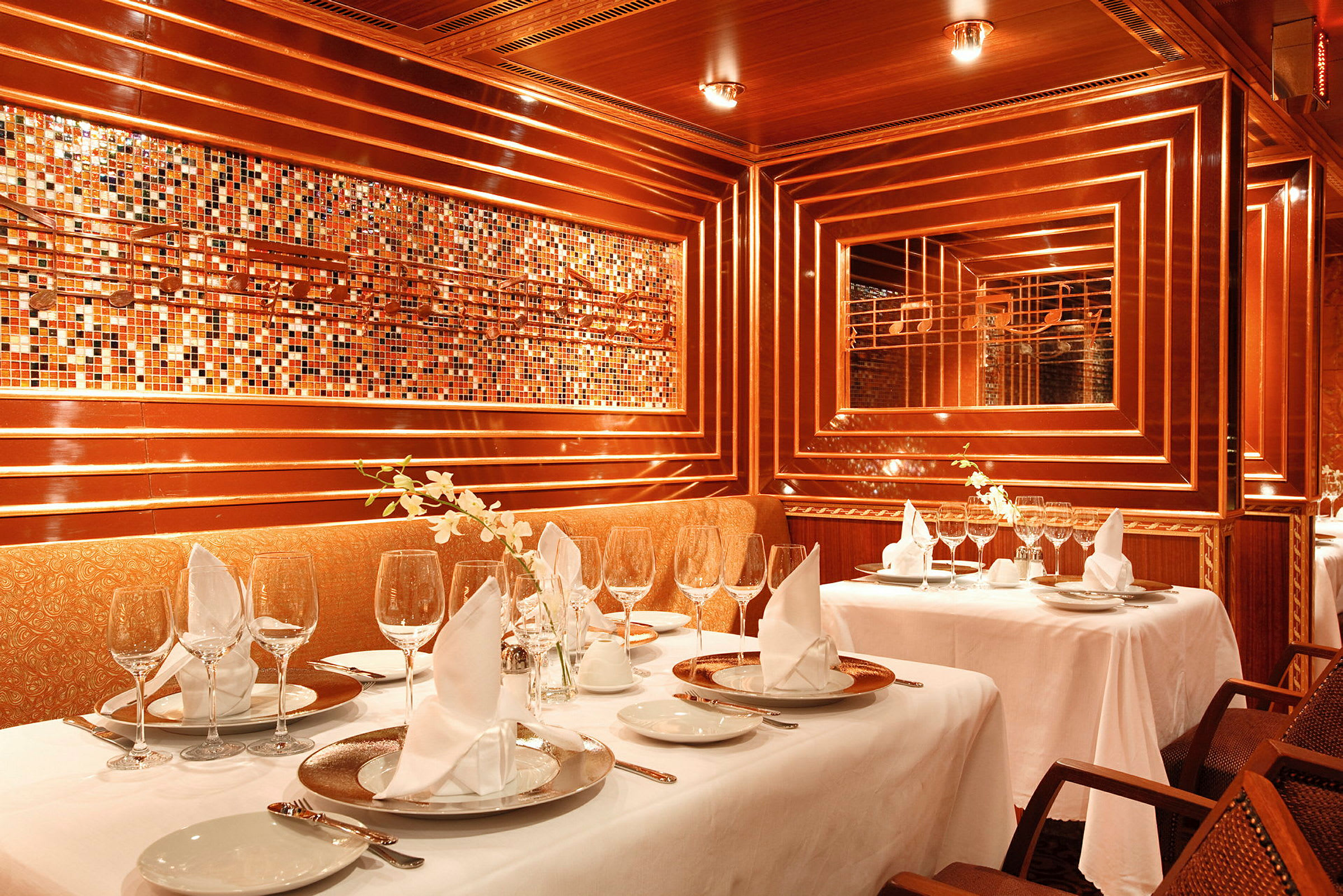En elegant restaurang med dukade bord, dekorationer och varma träpaneler. (AI-genererad text)