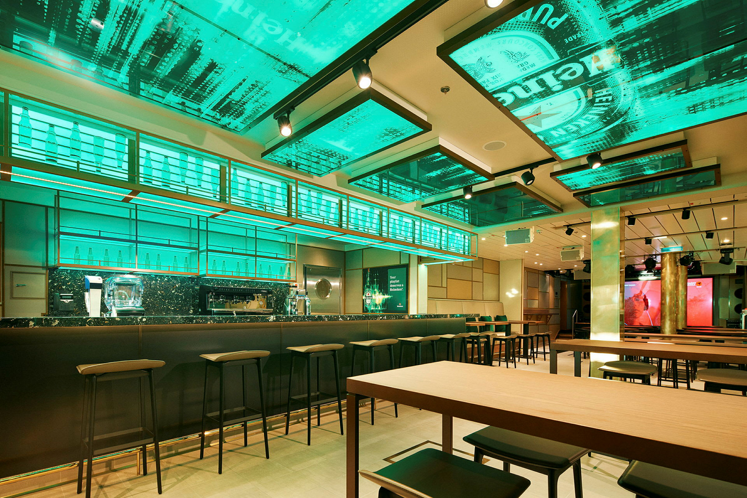 En modern bar med grönt ljus och höga stolar. (AI-genererad text)