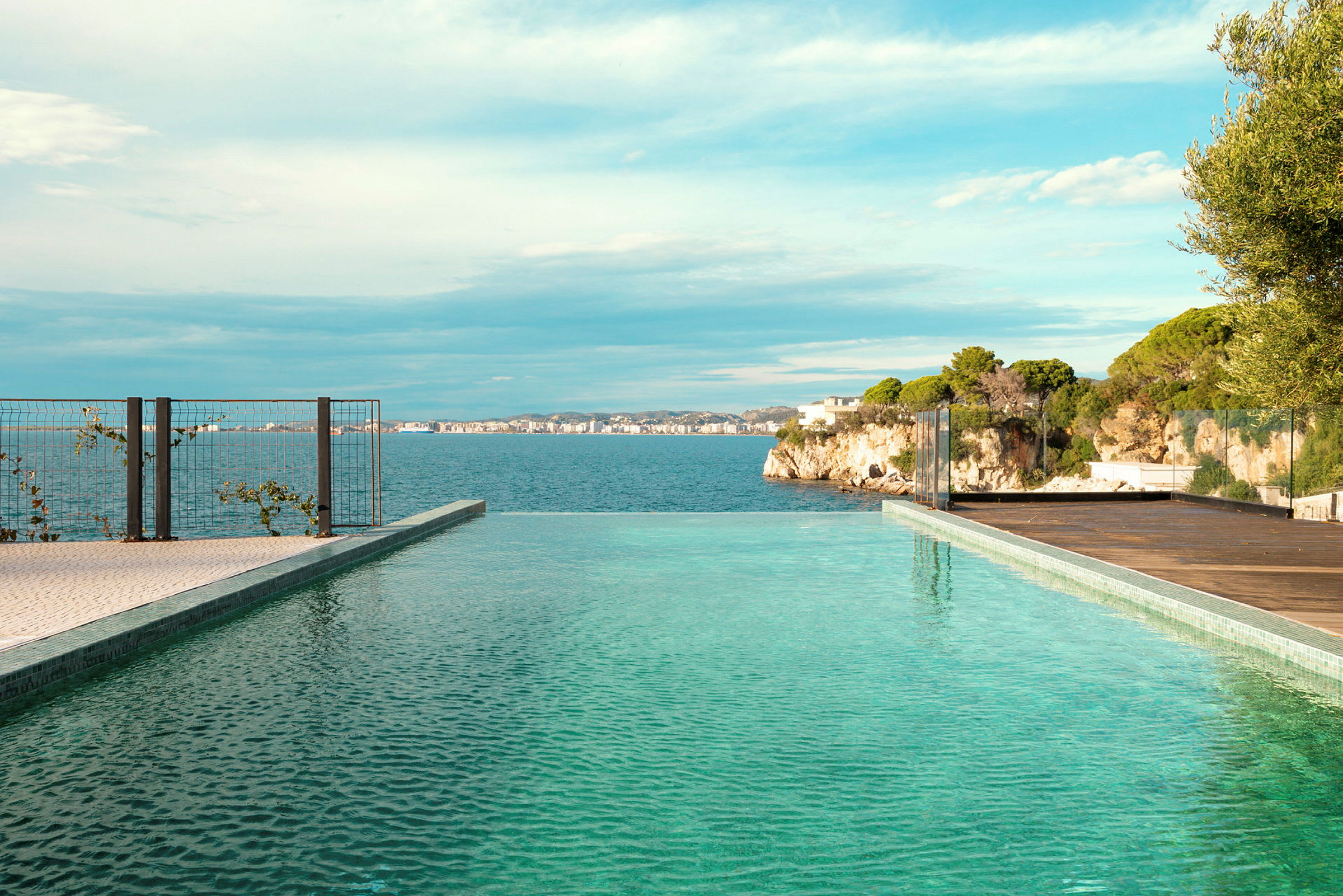 En infinitypool med utsikt över havet och klippor i bakgrunden. (AI-genererad text)