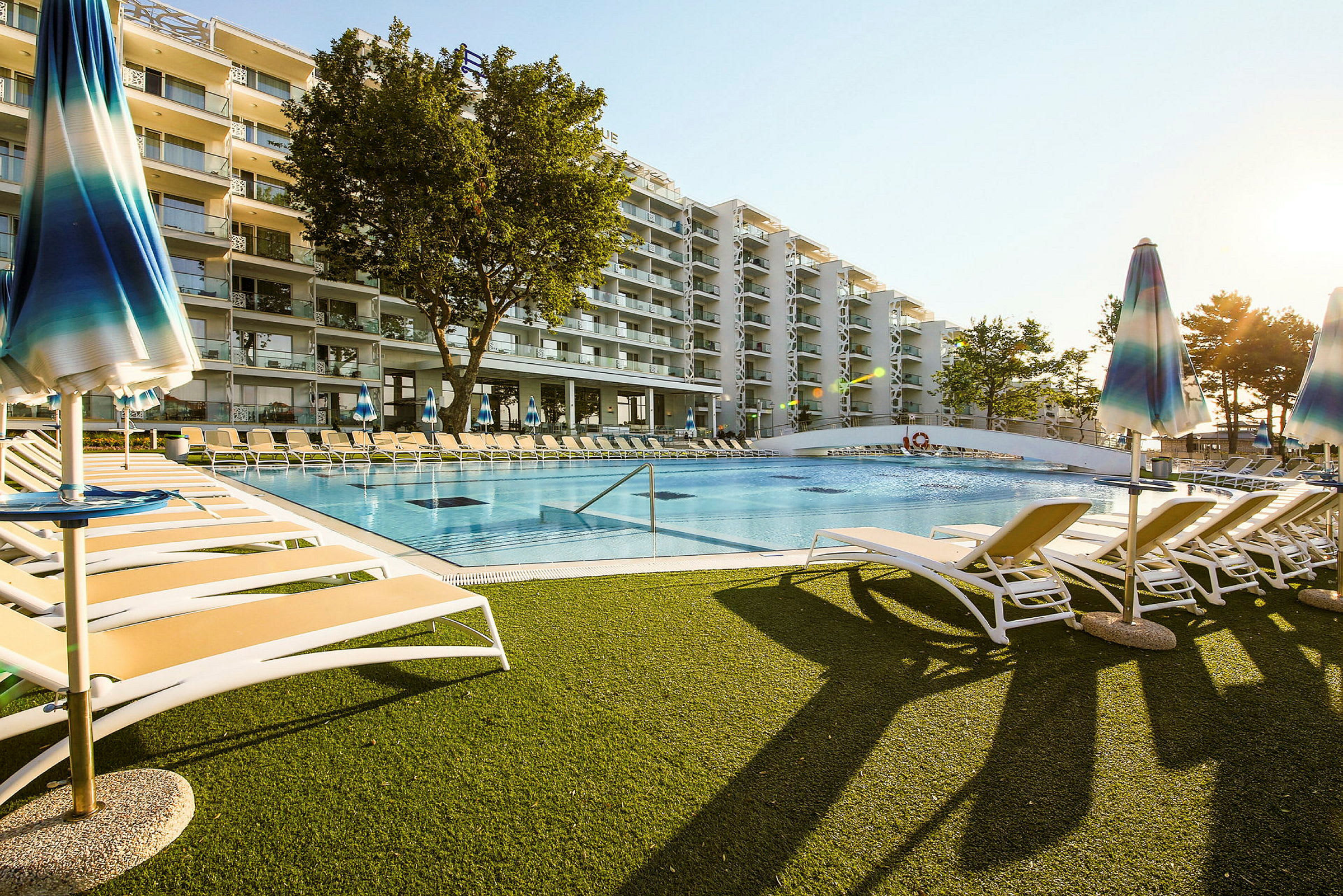 Hotell med pool och solstolar. (AI-genererad text)