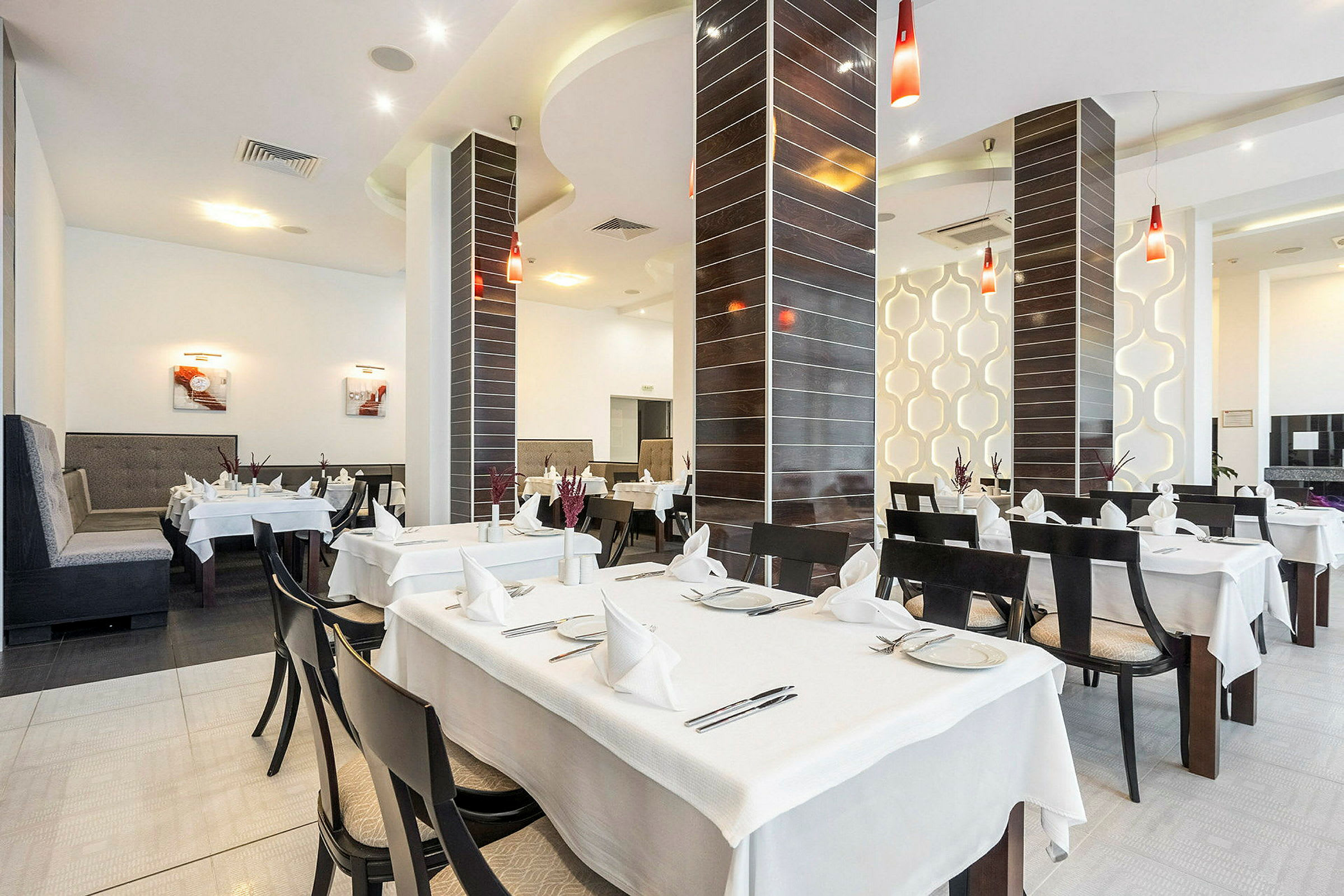 Bild på en restaurang med dukade bord och modern inredning. (AI-genererad text)
