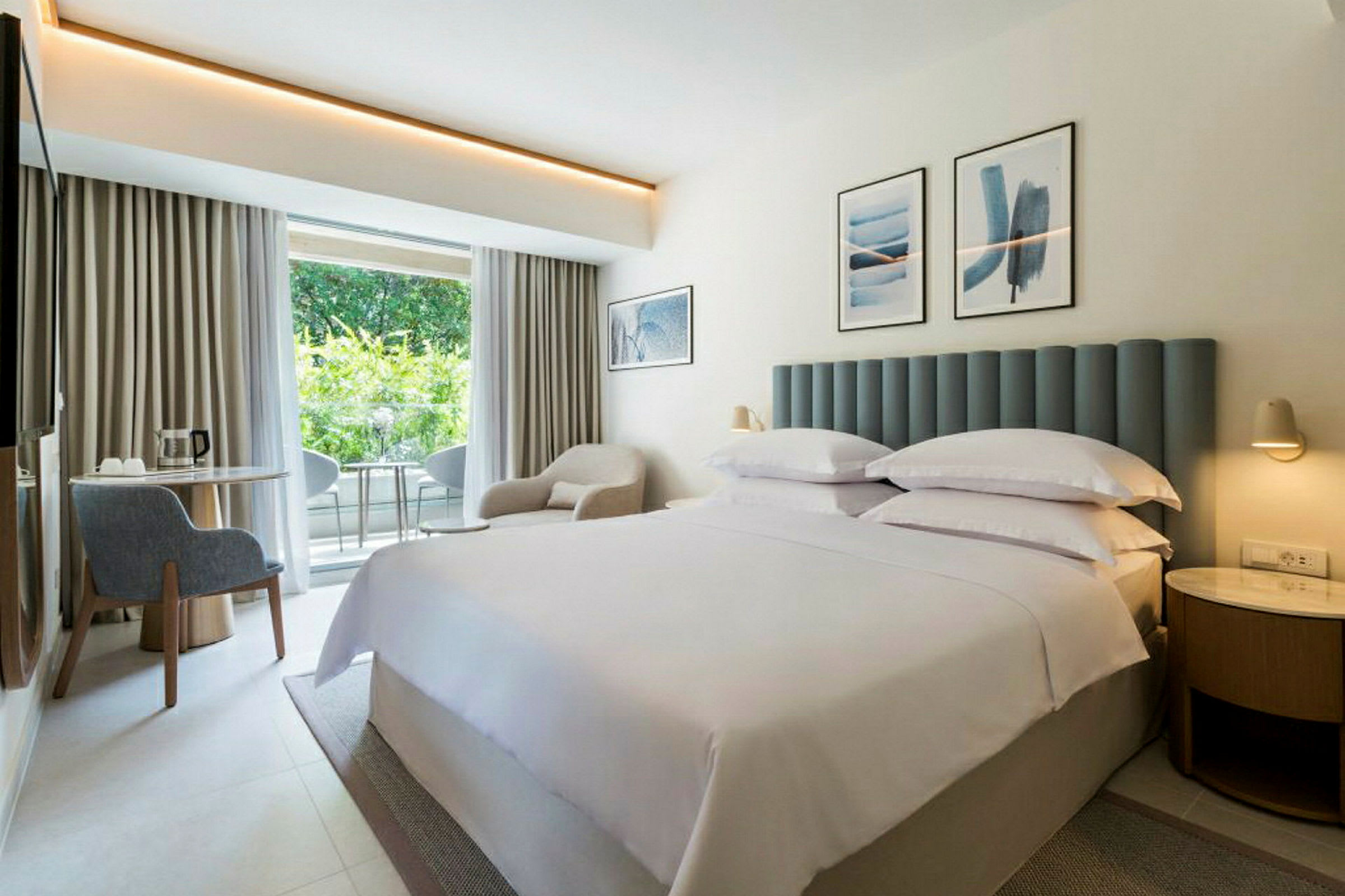 Hotellrum med dubbelsäng och inredning i ljusa färger. (AI-genererad text)