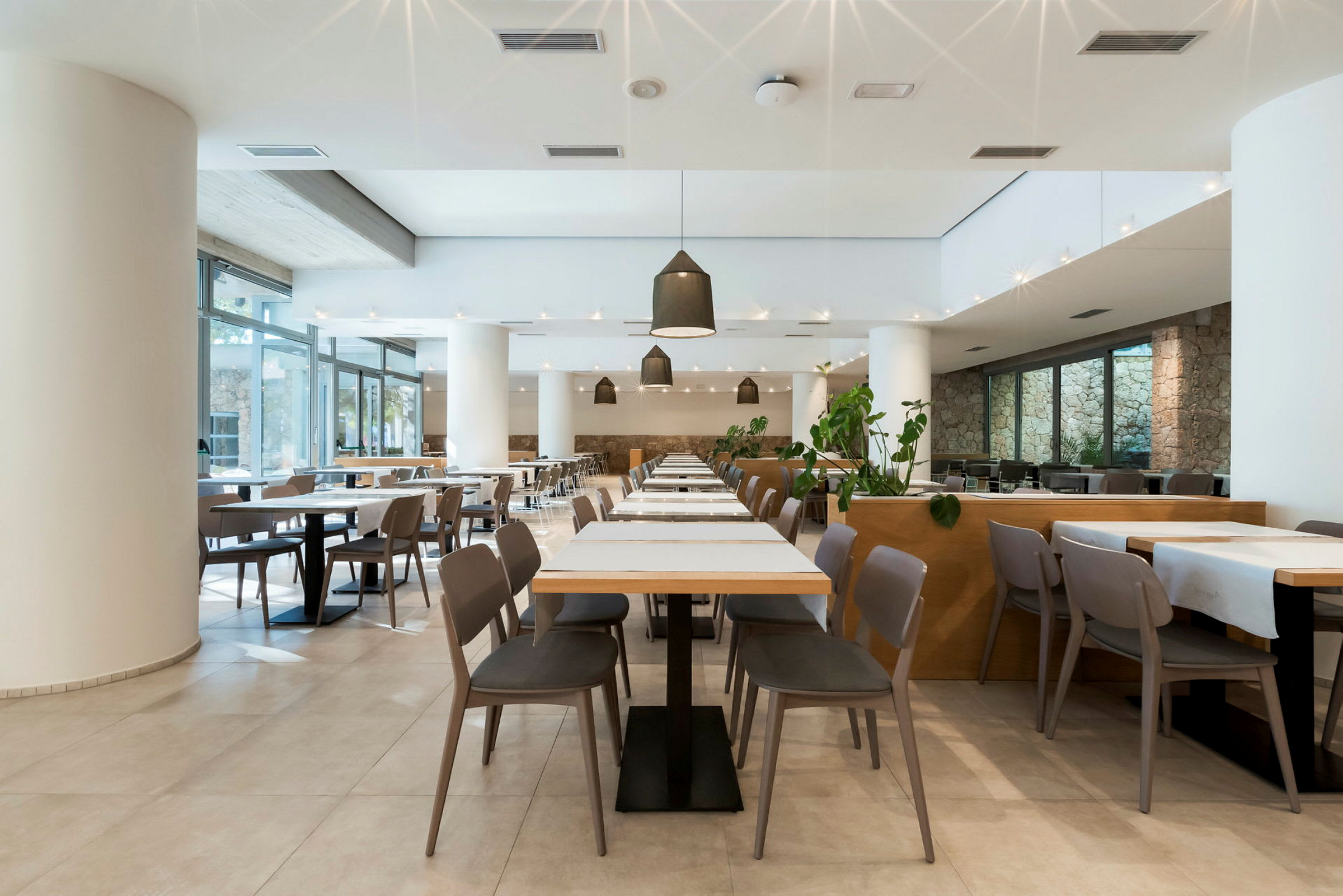 Stilrent inredd restaurang med bord och stolar. (AI-genererad text)