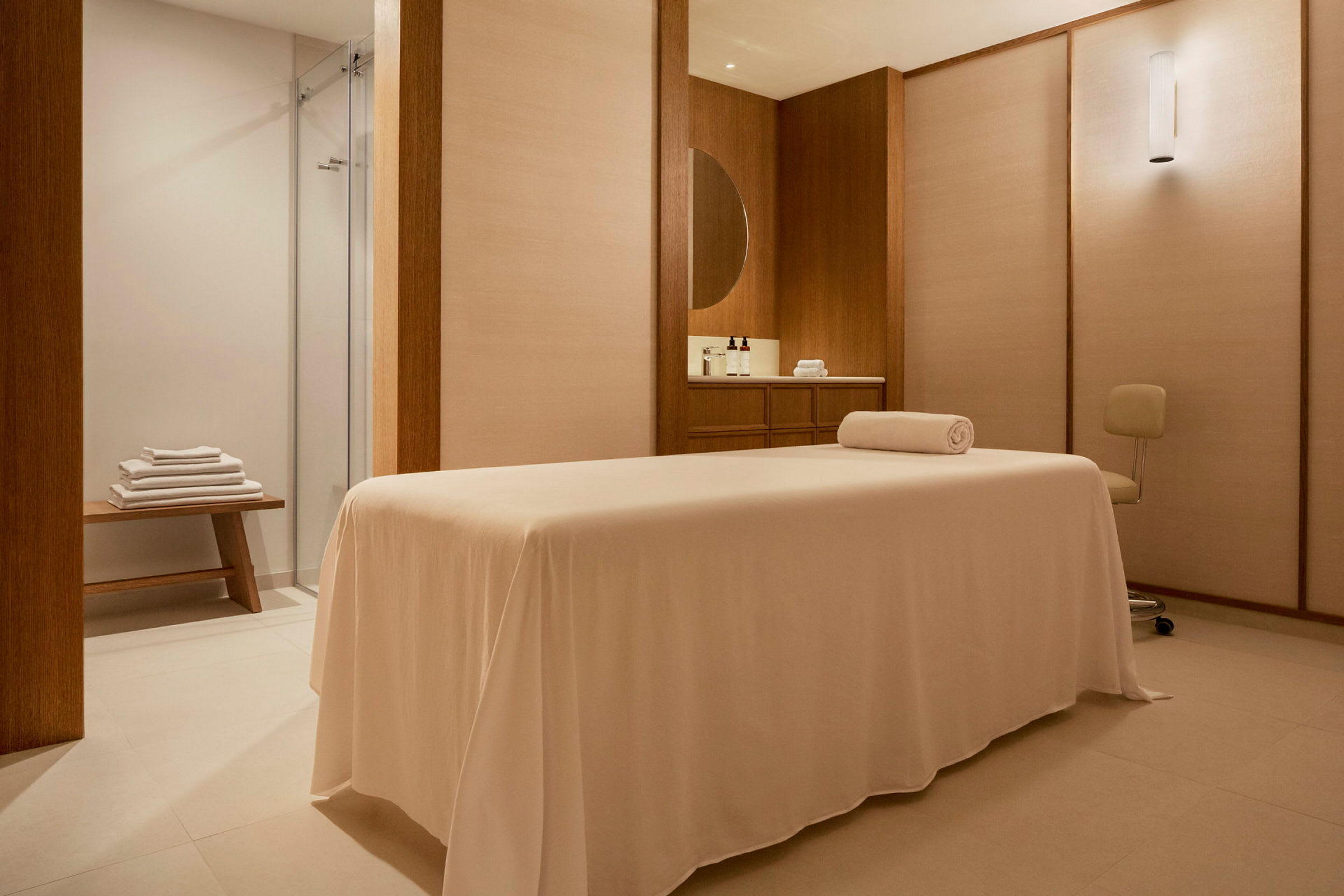 Massagebänk i ett spa-rum med minimalistisk inredning. (AI-genererad text)