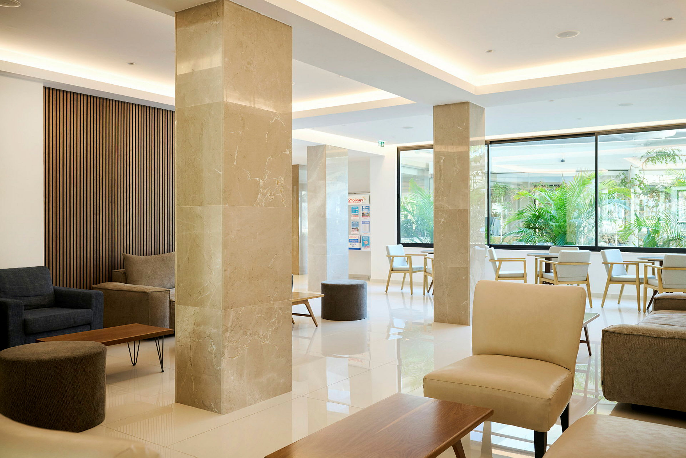 En ljus och modern hotellobby med sittplatser, soffor och bord. (AI-genererad text)
