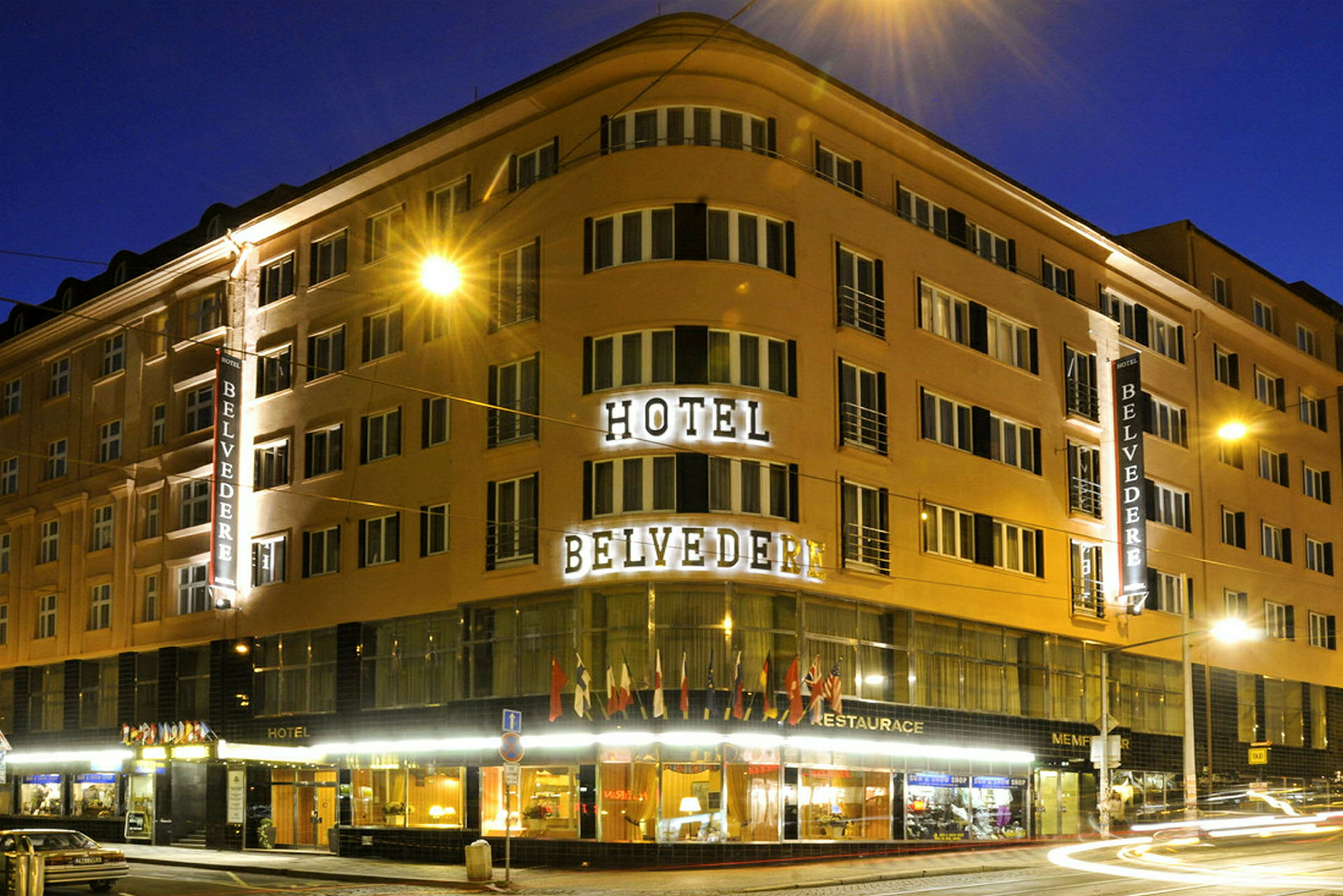 En utvändigt belyst byggnad på natten med texten "Hotel Belvedere". (AI-genererad text)
